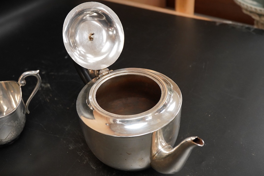 An Indian white metal three piece tea set, with engraved foliate decoration, gross weight 31.2oz.